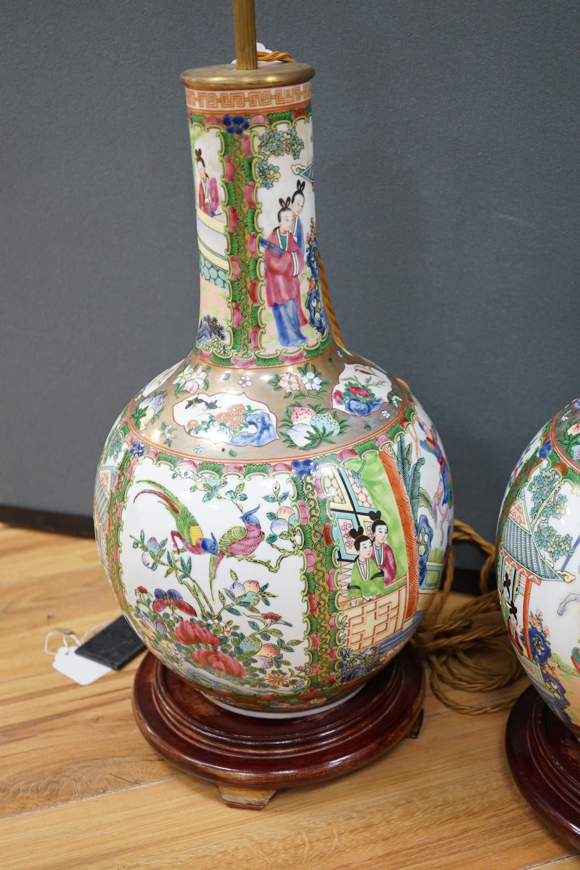 A pair of Chinese famille rose lamp bases on wooden stands, 50cm high